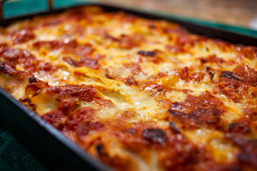 Homemade cheesy lasagne in a serving dish