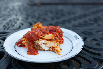 Homemade cheesy lasagne on a white plate