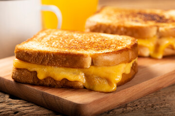 Grilled ham and cheese. Sandwich with cheese and ham on grill.
