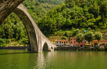Detail of arch of Historic Bridge in Italy - Ponte Della Maddalena over river Serchio.  Lucca, Italy