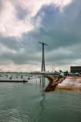 Landscape with small boats in the bay of Cadiz on a cloudy day with a huge communications tower in the background