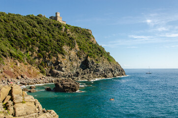 Fototapeta na wymiar Cala Del Leone, Castel Sonnino Italy. Coast castle on the rock with the sea. Tuscany