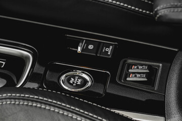 Seat heating and Super All Wheel controller buttons close up view. Car interior. Four-wheel drive button. S-AWC.