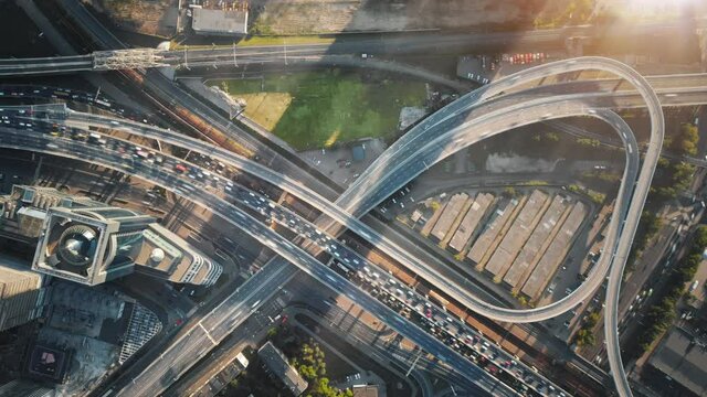 Beautiful aerial timelapse of multi-level highway in Moscow on a sunny evening. Big road junction with a lot of traffic illuminated by the sunset sun.