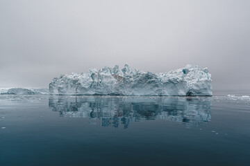 Arctic nature landscape with icebergs in Greenland icefjord with midnight sun sunset sunrise in the...