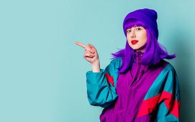 White girl with purple hair and 80s tracksuit on blue background