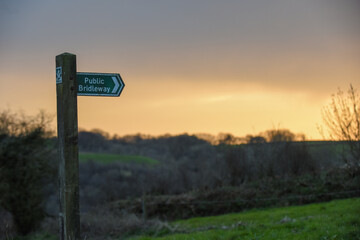 Wooden public bridleway sign to give directions in the countryside