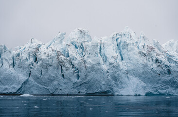 Arctic nature landscape with icebergs in Greenland icefjord with midnight sun sunset sunrise in the...