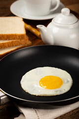 Breakfast with fried egg in the frying pan.