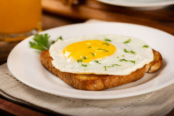 Breakfast with juice, coffee and toast with fried egg.