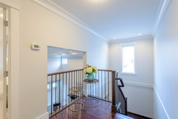 Beautiful living room interior with hardwood floors and vaulted ceiling in new luxury home. View of...