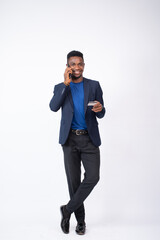 young black businessman making a phone call and holding his credit card