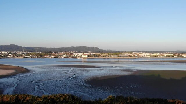 DRONE AERIAL FOOTAGE - The Northern Litoral Natural Park in Ofir, Esposende, Portugal. The Cavado River estuary at sunset.