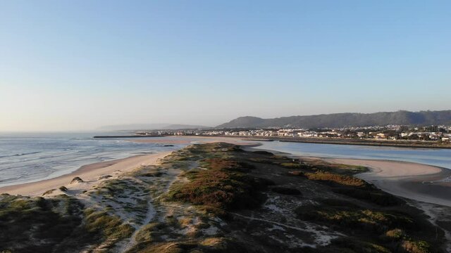 DRONE AERIAL FOOTAGE: Northern Litoral Natural Park in Ofir, Fao, Esposende, Portugal at sunset. The two sides of Restinga de Ofir. One facing the ocean, the other the estuary of C&aacute;vado River.