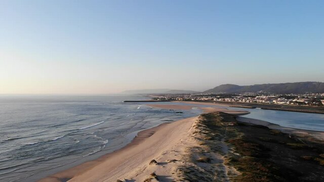 DRONE AERIAL FOOTAGE: Northern Litoral Natural Park in Ofir, Fao, Esposende, Portugal at sunset. The two sides of Restinga de Ofir. One facing the ocean, the other the estuary of C&aacute;vado River.