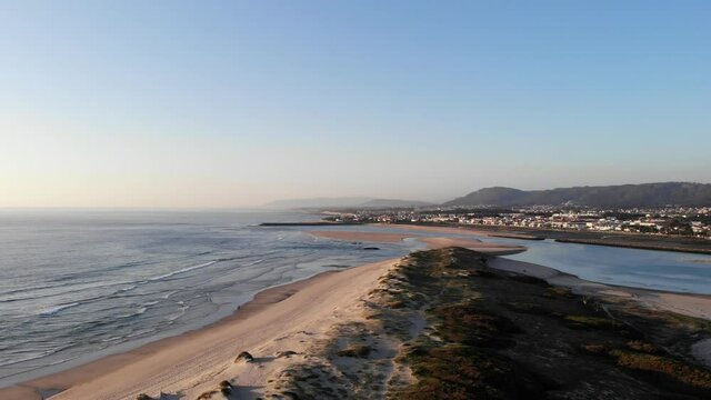 DRONE AERIAL FOOTAGE: Northern Litoral Natural Park in Ofir, Fao, Esposende, Portugal at sunset. The two sides of Restinga de Ofir. One facing the ocean, the other the estuary of C&aacute;vado River.