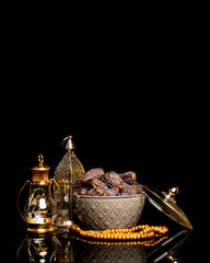 Eid and Ramadan lantern with Arabian coffee and dates set in black background. Festive greeting card, an invitation for Muslim holy month Ramadan Kareem or Eid al Adha and Eid al fiter