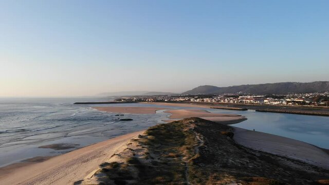 DRONE AERIAL FOOTAGE: Northern Litoral Natural Park in Ofir, Fao, Esposende, Portugal at sunset. The two sides of Restinga de Ofir. One facing the ocean, the other the estuary of C&aacute;vado River.