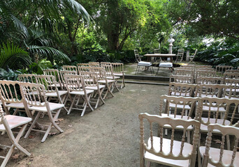 Wedding ceremony, row of chairs for guests in a park