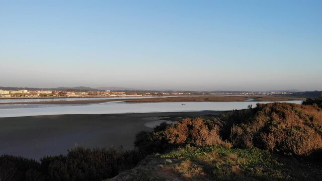 DRONE AERIAL FOOTAGE - The Northern Litoral Natural Park in Ofir, Esposende, Portugal. The Cavado River estuary at sunset.