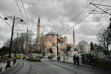 Fototapeta premium 04.03.2021. Turkey istanbul. Hagia sophia (ayasofya) mosque, church, or museum under huge clouds. Many tourist or people standing in front of old ancient building. Cloudscape and hagia sophia together