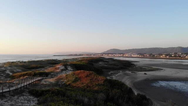 DRONE AERIAL FOOTAGE: Northern Litoral Natural Park in Ofir, Fao, Esposende, Portugal at sunset. The two sides of Restinga de Ofir. One facing the ocean, the other the estuary of C&aacute;vado River.