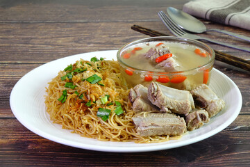 Stir fried rice noodles served with pork ribs soup, famous Phuket food