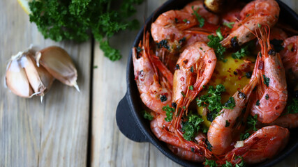 Shrimp in shells in a frying pan. Delicious fried prawns with spices.