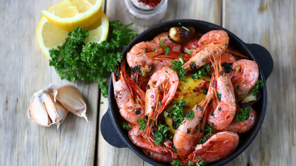 Shrimp in shells in a frying pan. Delicious fried prawns with spices.