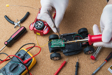 engineer repairing a children's toy car