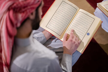 Fototapeta premium two muslim people in mosque reading quran together concept of islamic education