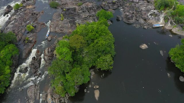 DRONE IMAGE NATURE AMAZON RIVER OIAPOQUE WATERFALLS DIVISION BETWEEN BRAZIL AND FRENCH GUIANA BOAT IN FLOREST