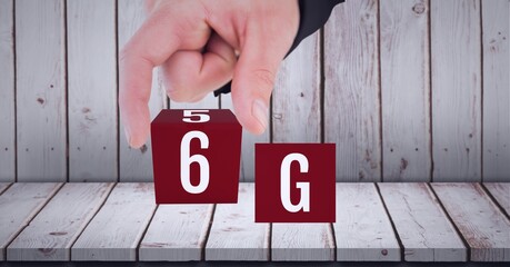 Composition of the word 6g in red cubes being touched by a person