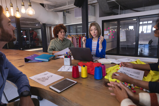 Diverse group of creative fashion designers colleagues brainstorming in meeting room