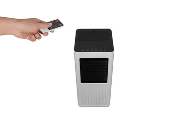 ็Hand holding  remote control to turn on the evaporative fan isolated on white background