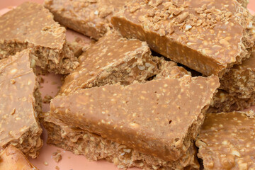 Oriental sweetness in the form of a broken bar of creamy fudge with nuts, peanuts.
