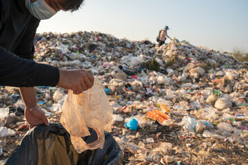 Poor people collecting garbage recycling men works looking for and finding on garbage...