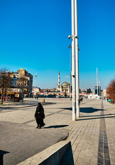Turkey. Istanbul 04.03.2021. istanbul well known square of taksim square during sunny day. Taksim mosque and tourists walking around. Square is not crowded as usual and women with black islamic niqab