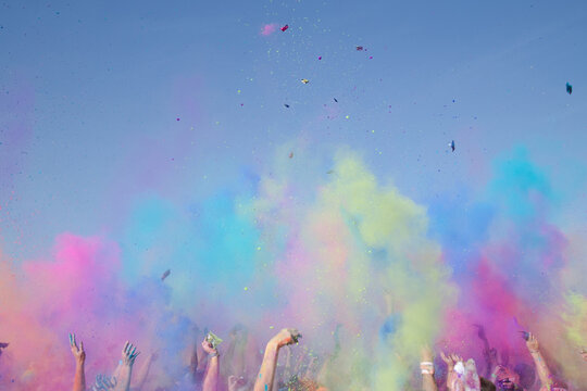 Crowed Of Peoples Hands Colourful Powder In The Air