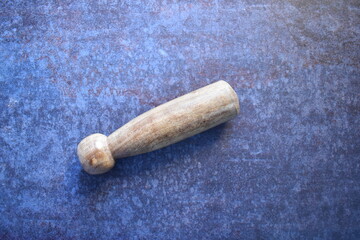 Wooden pestle isolated on concrete background