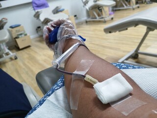 Donating blood, donating blood is in progress.