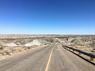  A view of an empty highway winding down into the badlands of Dinosaur Provincial Park, Alberta, Canada