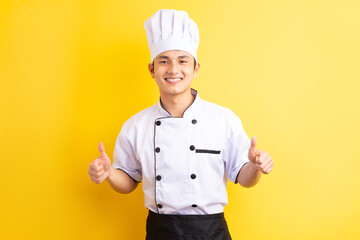 Image of Asian male chef on yellow background
