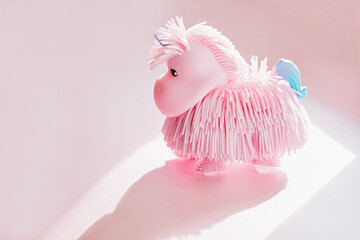 Pink toy silicon unicorn, cute fairy tale animal for children game, small cartoon toy for girl on the windowsill 