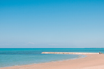 Beautiful landscape with white sand beach. Panoramic view on blue sky and azure coast sea on natural background. Luxury summer vacation.