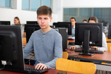 Young male student works at computer. High quality photo