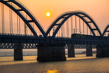 Fototapeta na wymiar The Godavari Arch Bridge is a bowstring-girder bridge that spans the Godavari River in Rajahmundry, India. It is the latest of the three bridges that span the Godavari river at Rajahmundry. 
