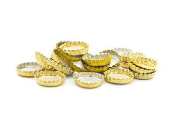 Metal beer bottle caps crownes in group isolated on white. Concept image to consumerism of alcohol during a quarantine.