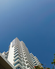 Obraz na płótnie Canvas White and blue building exterior. low angle view of modern building under blue sky