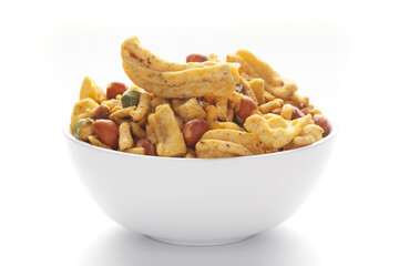 Close up of plane salty Golden Mixture Indian namkeen (snacks) on a ceramic white bowl.